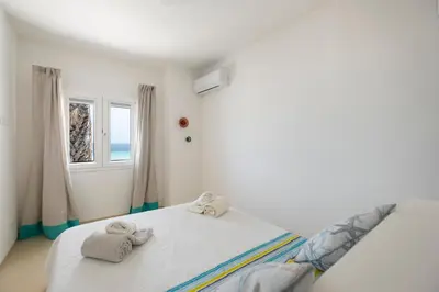 a bedroom with a bed with towels on it at Villa Acquamarina sul mare in San Vito lo Capo
