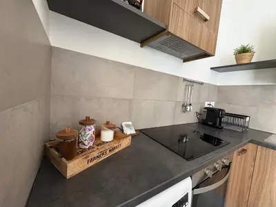 a kitchen with a washing machine and a sink at I Mori Apartment in Palermo