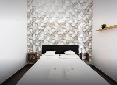 a white bedroom with a bed with two towels on it at I Mori Apartment in Palermo