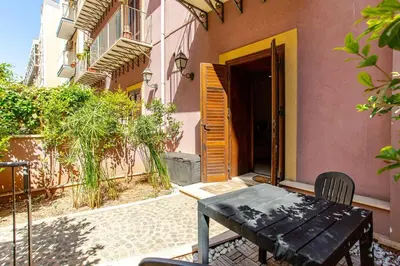a table and chairs sitting outside of a building at Nino's house in Palermo