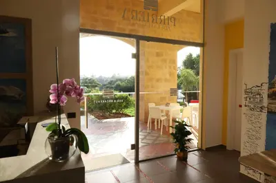 a door to a patio with a table and chairs at b&b Pirriera in Bagheria