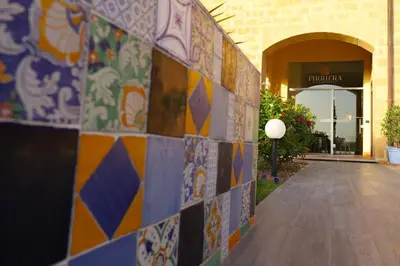 a building with colorful tiles on the side of it at b&b Pirriera in Bagheria