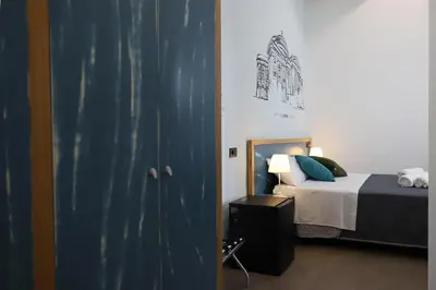 a bedroom with a bed and a blue door at b&b Pirriera in Bagheria