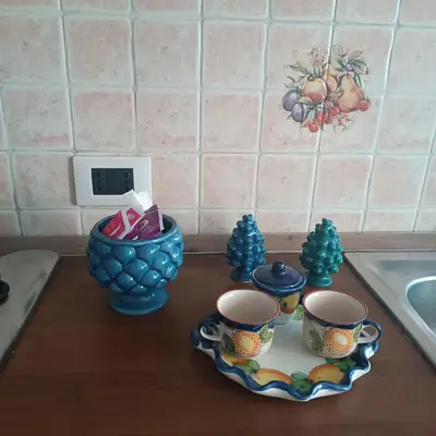 a counter top with two cups and a bowl on it at Sicilia Bedda isolotto in Isola delle Femmine