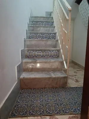 a stairway with blue and white tiles on the stairs at Sicilia Bedda isolotto in Isola delle Femmine