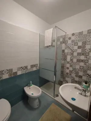 a bathroom with a sink and a toilet and a shower at Sicilia Bedda isolotto in Isola delle Femmine