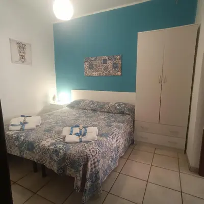 a bedroom with two beds with towels on them at Sicilia Bedda isolotto in Isola delle Femmine