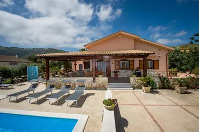 a villa with a swimming pool and a house at Villa Mirto in Castellammare del Golfo