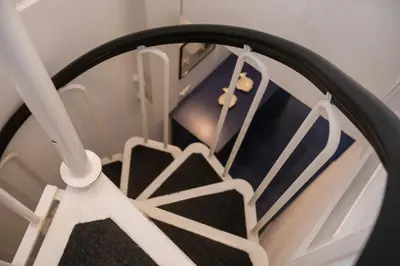 a close up of a round mirror with a staircase at La casa del Rinoceronte - Scopello, con accesso diretto al mare in Castellammare del Golfo