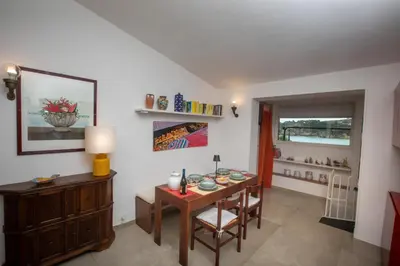 a room with a table and chairs and a dining room at La casa del Rinoceronte - Scopello, con accesso diretto al mare in Castellammare del Golfo