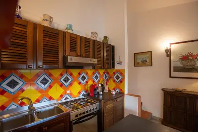 a kitchen with a sink and a stove at La casa del Rinoceronte - Scopello, con accesso diretto al mare in Castellammare del Golfo