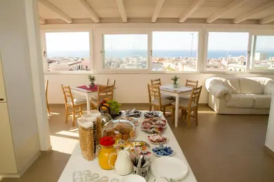 a living room with a table with food on it at La Balestra B&B in Balestrate