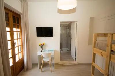 a room with a table and a bed and a bedroom at La Balestra B&B in Balestrate