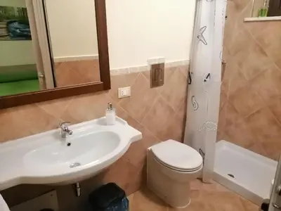 a bathroom with a sink and a toilet and a shower at Baglio delle Rondini in Bagheria