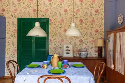 a dining room with a table with a green door at Domus Sicily - Villa Conca d'Oro with Pool in Palermo