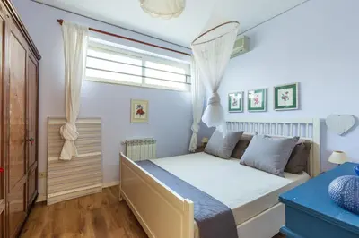 a bedroom with a bed and a window at Domus Sicily - Villa Conca d'Oro with Pool in Palermo