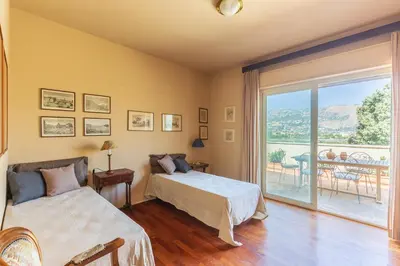 a bedroom with two beds and a balcony at Domus Sicily - Villa Conca d'Oro with Pool in Palermo