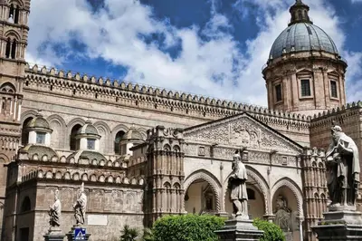a large building with a clock tower and a statue at Sant'Agostino Apartment with Terrace by Wonderful Italy in Palermo