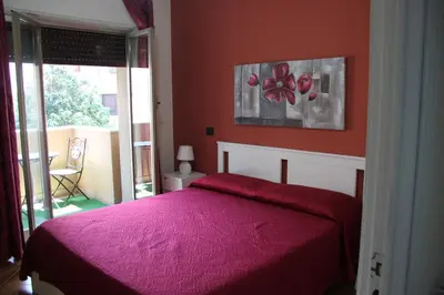 a bedroom with a bed with a pink blanket at B&B Alexander-Room and Breakfast in Palermo