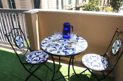 a blue and white table and chairs on a balcony at B&B Alexander-Room and Breakfast in Palermo