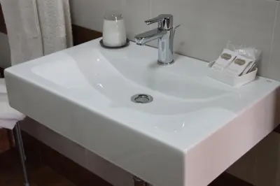 a white bathroom sink with a chrome faucet at B&B Alexander-Room and Breakfast in Palermo