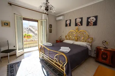 a bedroom with a bed with a gold bed frame at B&B Chiaro di Luna in Corleone