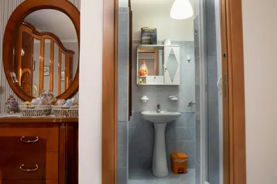a bathroom with a sink and a mirror at B&B Chiaro di Luna in Corleone