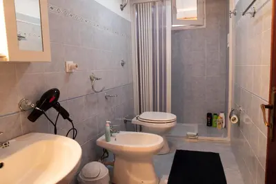 a bathroom with a white toilet and a sink at B&B Chiaro di Luna in Corleone