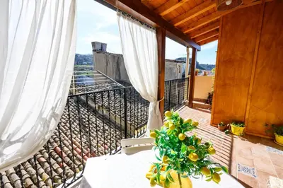 a balcony with a plant sitting on a table at B&B Chiaro di Luna in Corleone