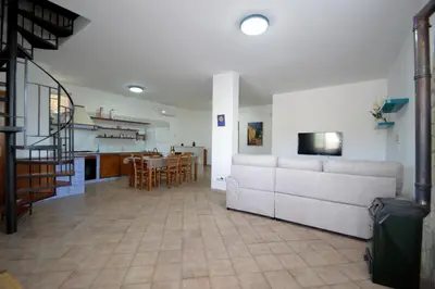 a living room with a white couch and a table at Villa Stella Cinese in Alcamo