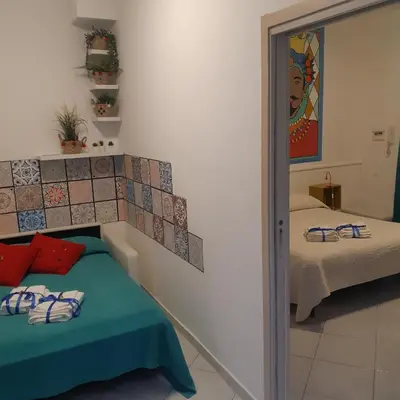 a bedroom with a mirror next to a bed at Casuzza Ballarò in Palermo