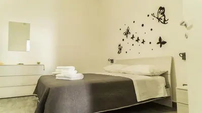 a bedroom with a bed with butterflies on the wall at Il Nido del Gabbiano in Bagheria