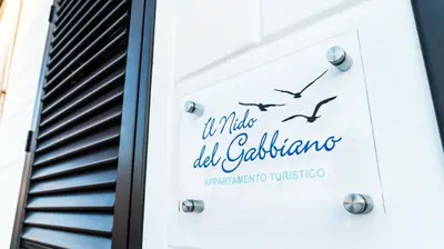 a sign for a white wedding calligraphy restaurant at Il Nido del Gabbiano in Bagheria