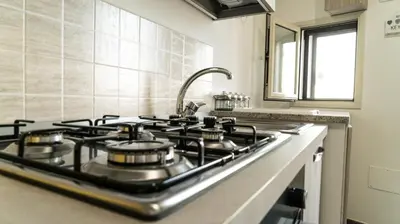 a stove top in a kitchen with a sink at Il Nido del Gabbiano in Bagheria