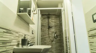 a bathroom with a shower with a sink and a shower at Il Nido del Gabbiano in Bagheria