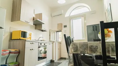a small kitchen with a table and a microwave at Il Nido del Gabbiano in Bagheria