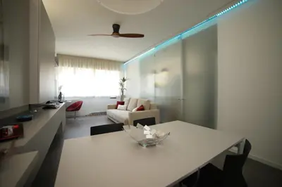 a living room with a white table and a couch at Maison Heloise in Palermo