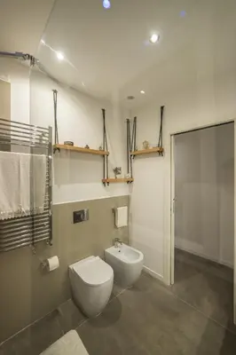 a bathroom with a toilet and a sink and a shower at Maison Heloise in Palermo