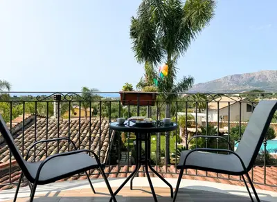 a patio with two chairs and a table on a balcony at Case Vacanza Zeus in Trappeto