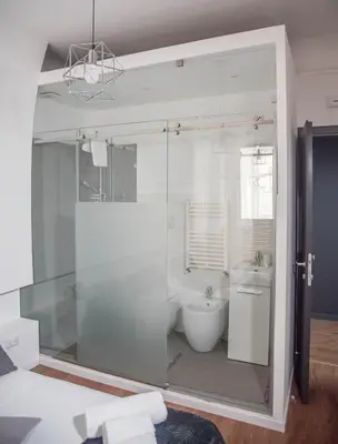a bathroom with a glass shower and a toilet at Residenza del Castillo in Palermo