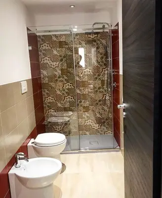 a bathroom with a shower and a toilet and a sink at Residenza del Castillo in Palermo