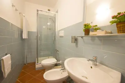 a bathroom with a sink and a toilet and a shower at Residenza Normanna in Palermo