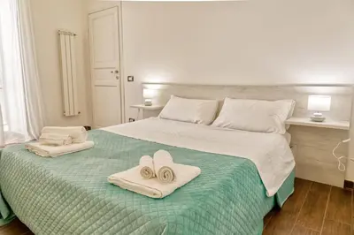 a bedroom with a bed with towels on it at Pupi 93 in Palermo