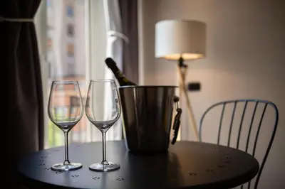 a table with two wine glasses and a bucket on it at Pupi 93 in Palermo