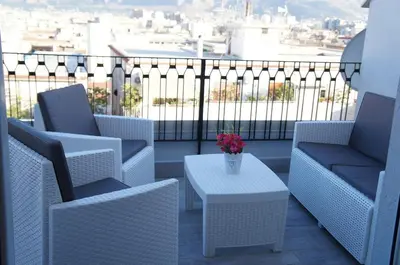 a balcony with chairs and a table with a view at THE VIEW in Palermo