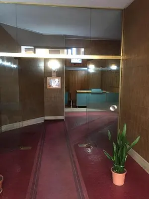 a lobby with a potted plant in the middle of a building at THE VIEW in Palermo