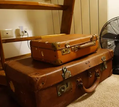 two old suitcases stacked on top of each other at Cassàri Suite in Palermo