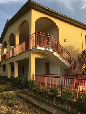 a building with red railings on the side of it at Villa Augustea in Alcamo