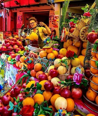 a display of fruits and vegetables in a market at Normanni Homes in Palermo