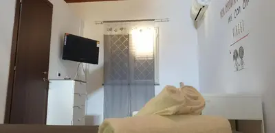 a living room with a tv and a couch and a window at Normanni Homes in Palermo